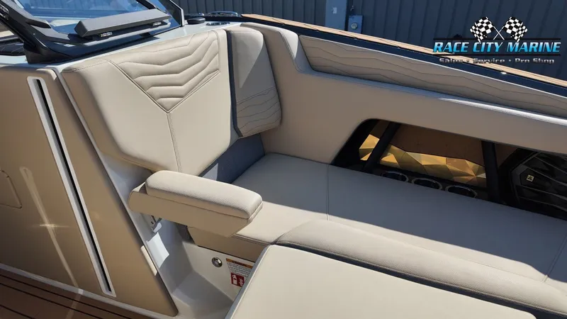 Slide: The Image of The image shows the interior of a Nautique G25 boat with beige upholstery and modern details. - 12