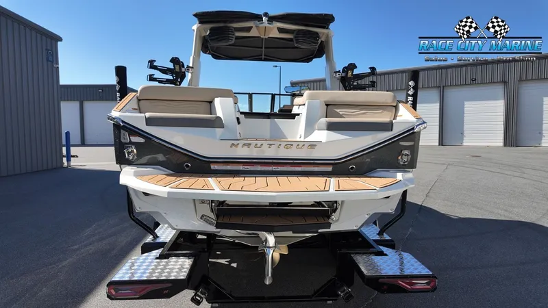 Slide: The Image of The image shows the rear of a 2027 Nautique G25 boat with a spacious swim platform. - 4