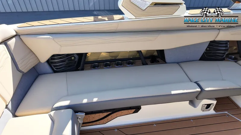 Slide: The Image of The image shows the luxurious seating area of a Nautique G25 boat with elegant upholstery and speakers. - 33