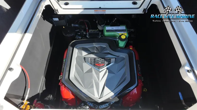 Slide: The Image of The engine compartment of a 2027 Nautique G25 features a powerful PCM engine with red accents. - 24