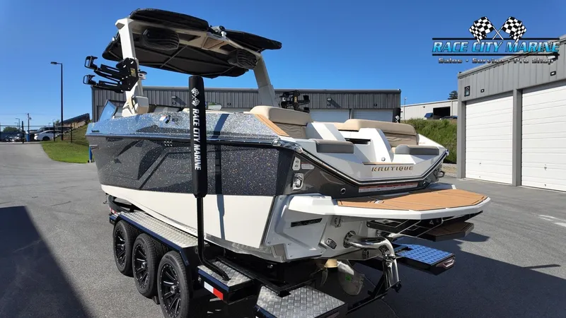 Slide: The Image of A 2027 Nautique G25 boat on a trailer in a storage area. - 7