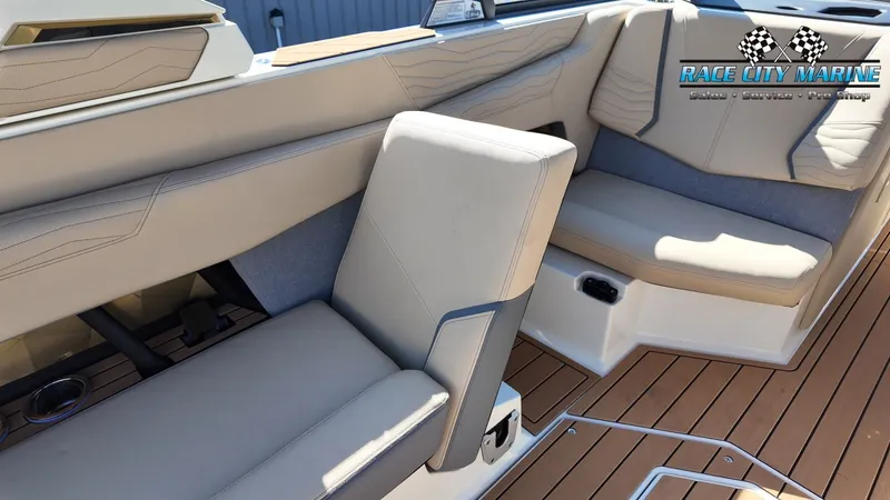 Slide: The Image of The image shows the interior of a Nautique G25 boat with beige seats and wooden flooring. - 20