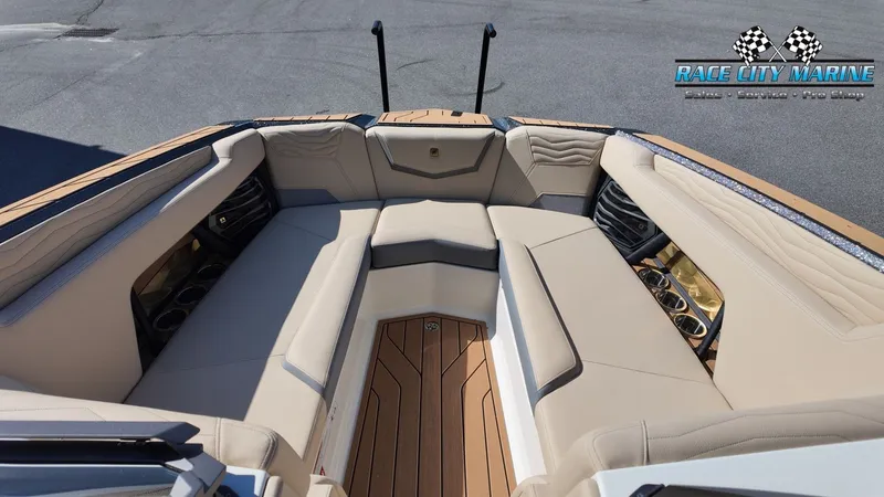 Slide: The Image of The image shows the bow area of a Nautique G25 boat with beige upholstery and wood flooring. - 40