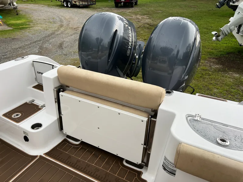 Slide: The Image of A 2018 Sportsman Open 252 Center Console with twin Yamaha outboard engines on a trailer. - 13