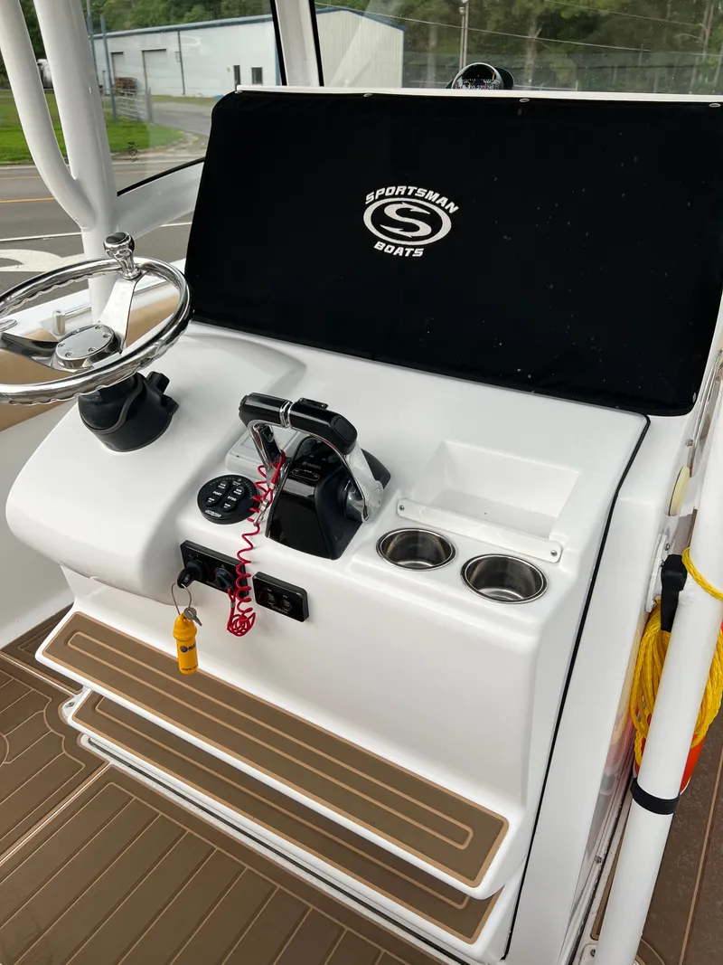 Slide: The Image of Sportsman Open 252 Center Console 2018: Helm with steering wheel, controls, and cup holders. - 8