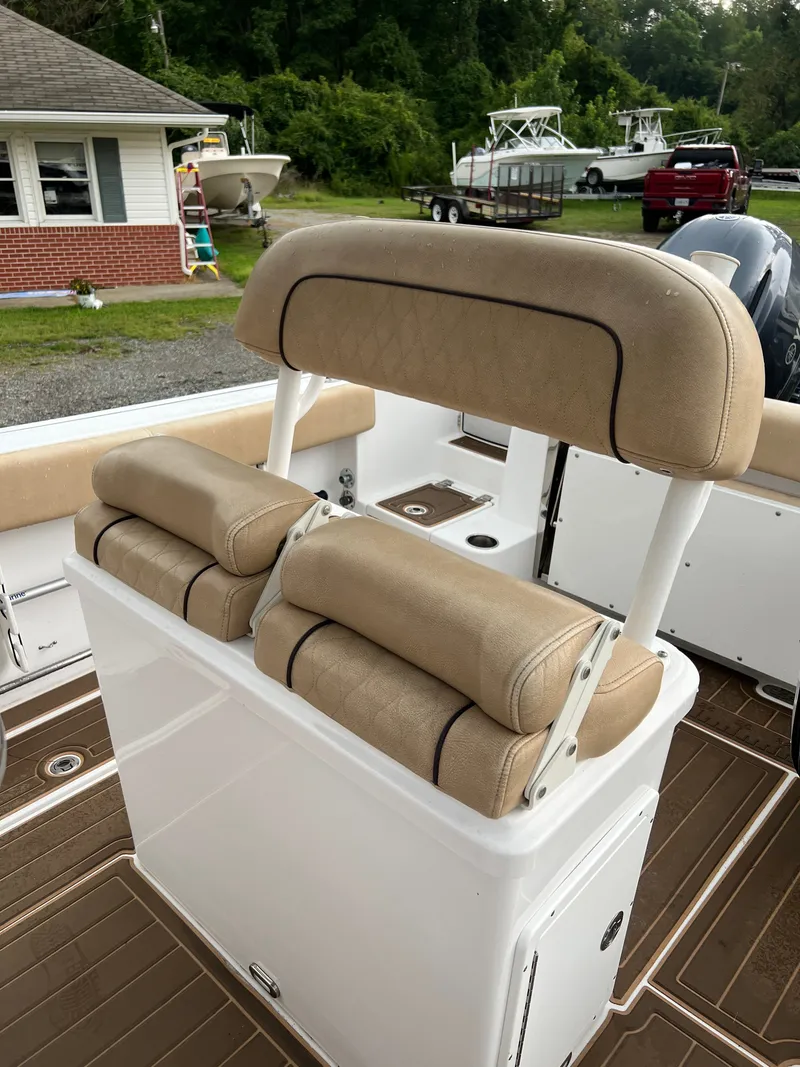 Slide: The Image of The image shows the beige upholstery of the seats on a Sportsman Open 252 Center Console boat. - 12