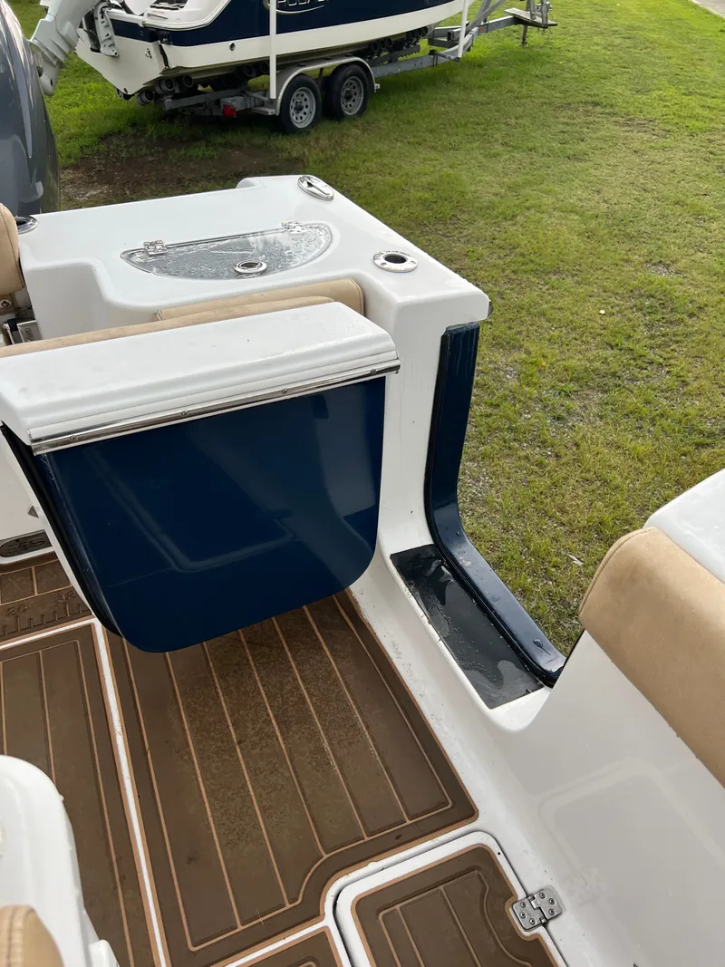 Slide: The Image of The image shows the cockpit of a 2018 Sportsman Open 252 Center Console boat with blue and white details. - 3