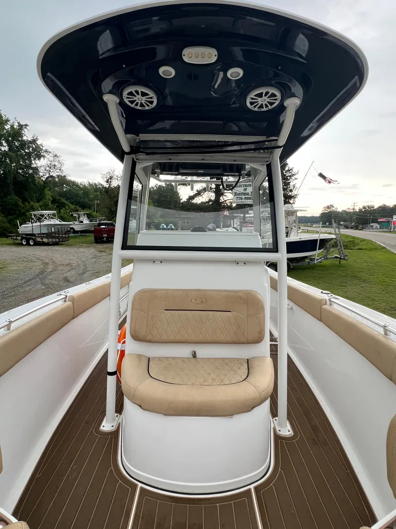 Slide: The Image of The image shows the cockpit of a 2018 Sportsman Open 252 Center Console boat with cushioned seating. - 6