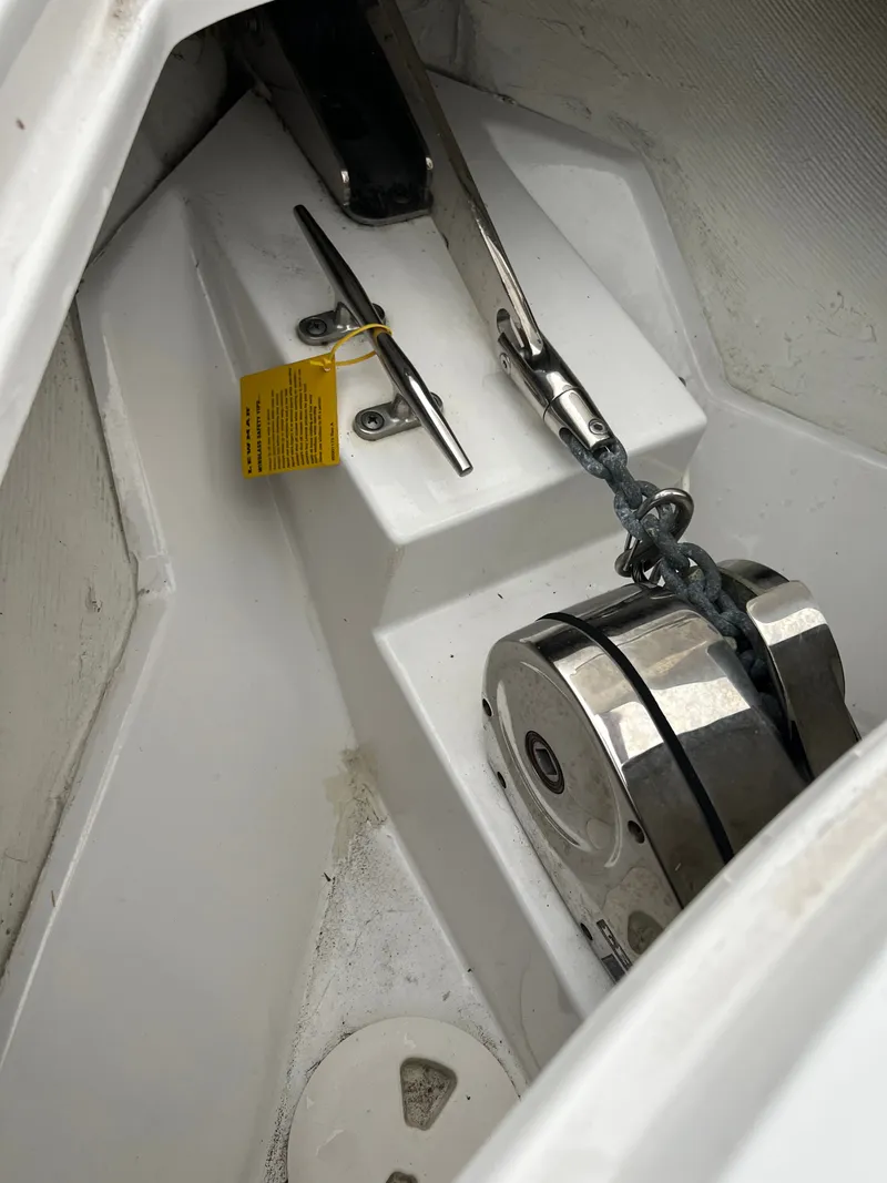 Slide: The Image of Close-up of an anchor locker with chain and windlass on a Sportsman Open 252 Center Console boat. - 18