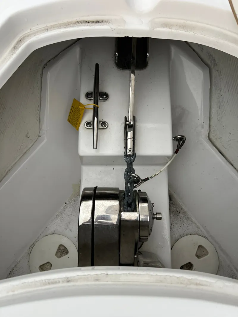 Slide: The Image of Close-up of an anchor locker with stainless steel windlass system on a Sportsman Open 252 Center Console boat. - 17