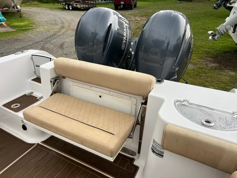 Slide: The Image of The image shows the stern of a 2018 Sportsman Open 252 Center Console boat with two outboard engines. - 14