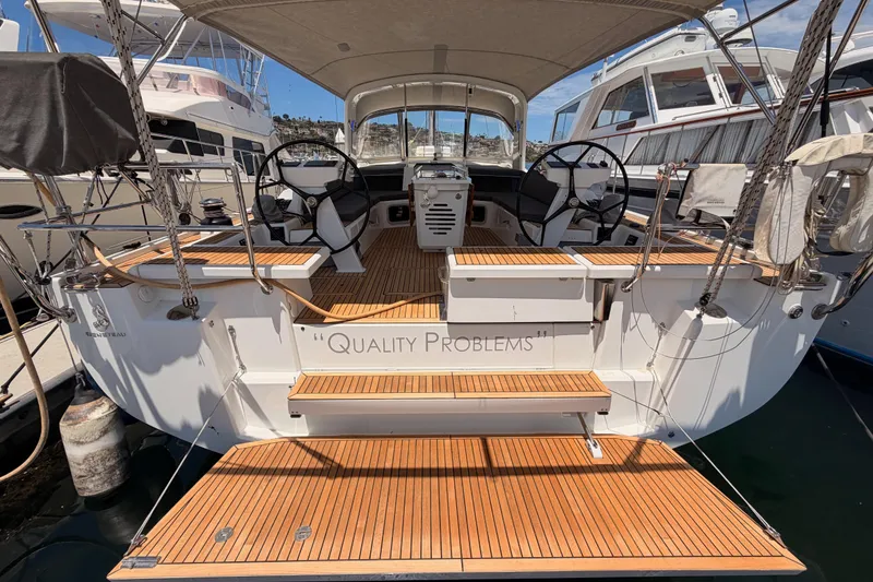 Slide: The Image of Beneteau Oceanis 51.1 yacht, 2020 model, docked with elegant wooden deck and dual steering wheels. - 29