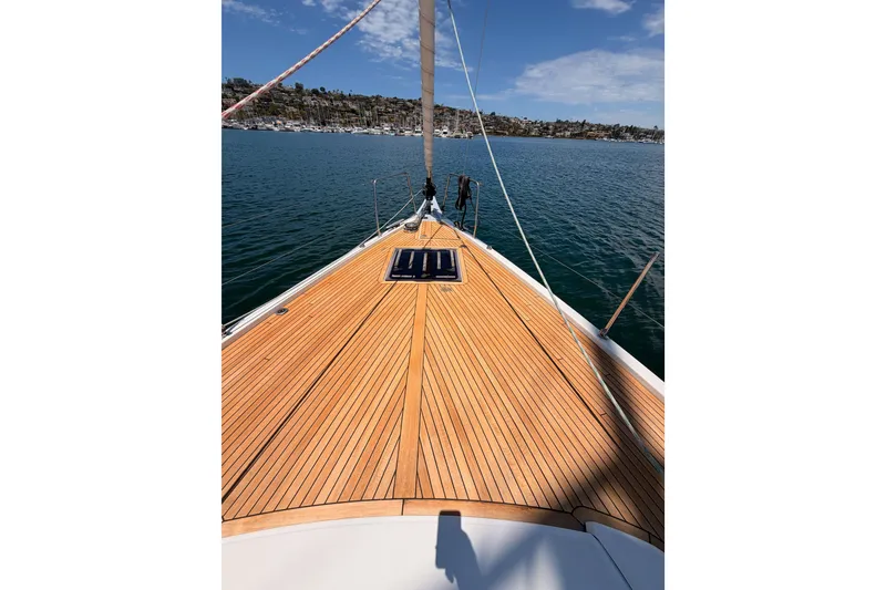 Slide: The Image of Beneteau Oceanis 51.1 sailboat deck, 2020 model, on calm waters under blue sky. - 13