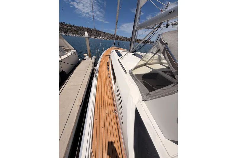 Slide: The Image of 2020 Beneteau Oceanis 51.1 yacht docked, showcasing sleek deck design and marina view. - 12