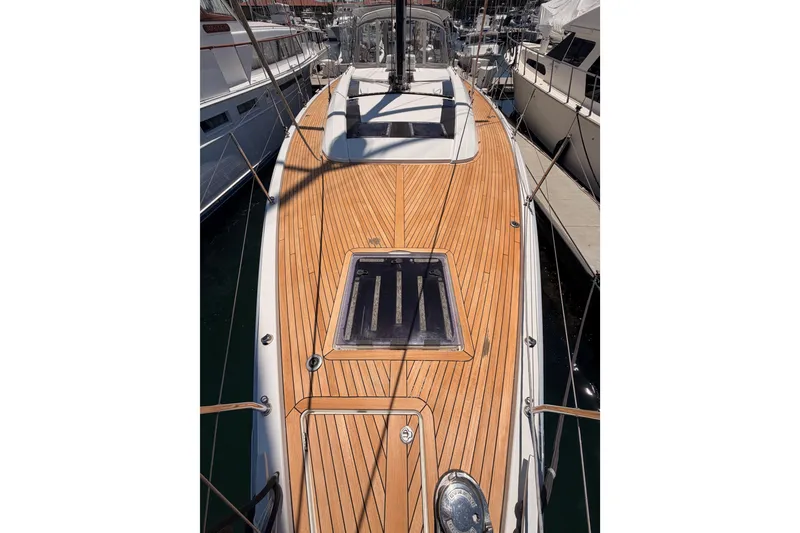 Slide: The Image of 2020 Beneteau Oceanis 51.1 yacht with sleek wooden deck, docked at marina. - 20