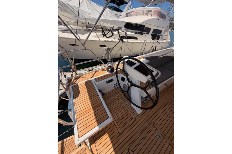 Slide: The Image of Cockpit of 2020 Beneteau Oceanis 51.1 yacht with teak decking and steering wheel. - 32