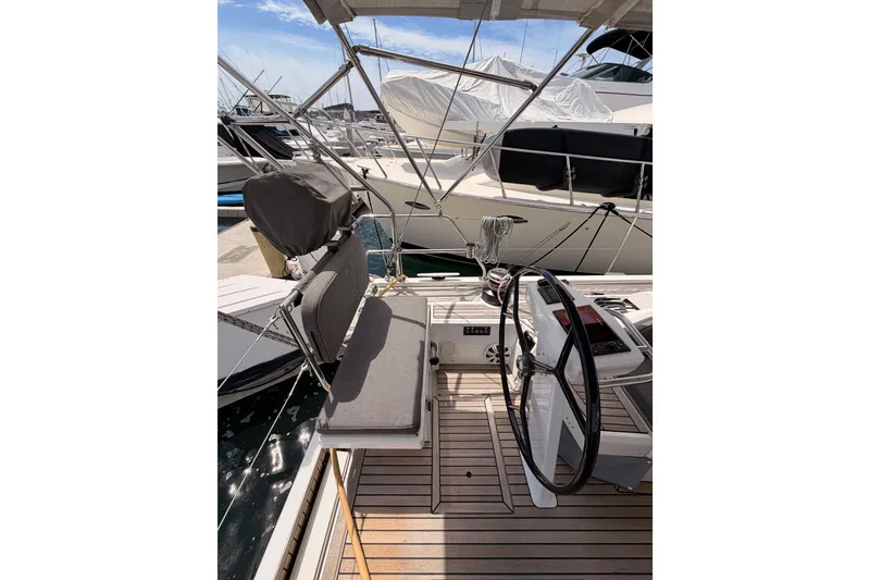 Slide: The Image of Cockpit of 2020 Beneteau Oceanis 51.1 sailboat with steering wheel and seating. - 31