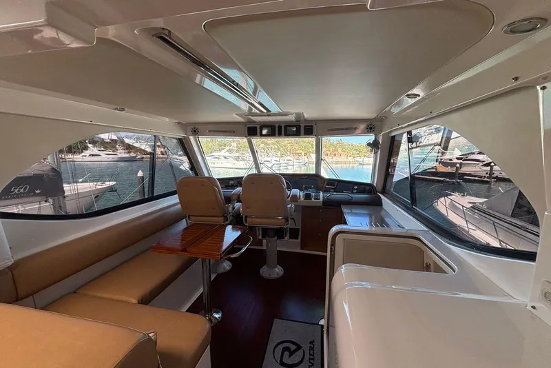 Slide: The Image of Interior of 2007 Riviera 51 Enclosed Flybridge yacht with seating and helm station. - 11