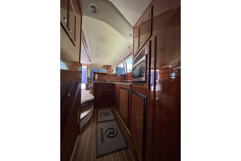 Slide: The Image of Interior of 2007 Riviera 51 Enclosed Flybridge yacht with wood cabinetry and modern amenities. - 13
