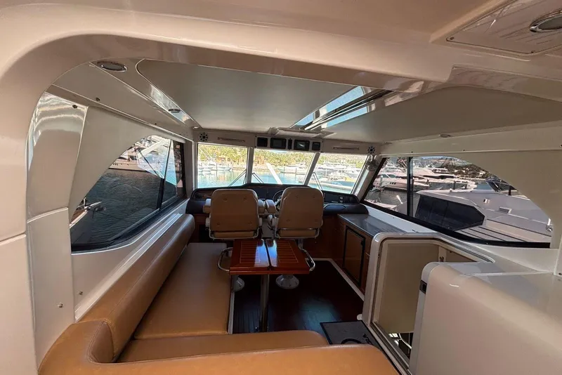 Slide: The Image of Interior of 2007 Riviera 51 Enclosed Flybridge yacht with seating and helm station. - 8