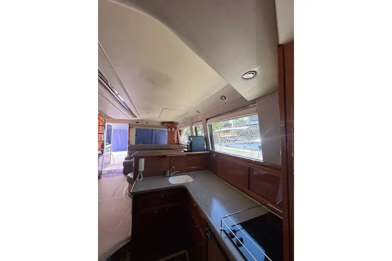 Slide: The Image of Interior of 2007 Riviera 51 Enclosed Flybridge yacht with modern kitchen and large windows. - 15