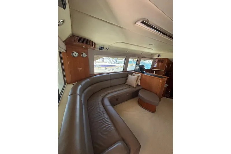 Slide: The Image of Luxurious interior of 2007 Riviera 51 Enclosed Flybridge with leather seating and wood accents. - 14