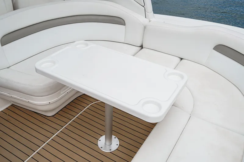 Slide: The Image of The image shows the seating area of a 2006 Sea Ray 340 Sundancer with a white table. - 9