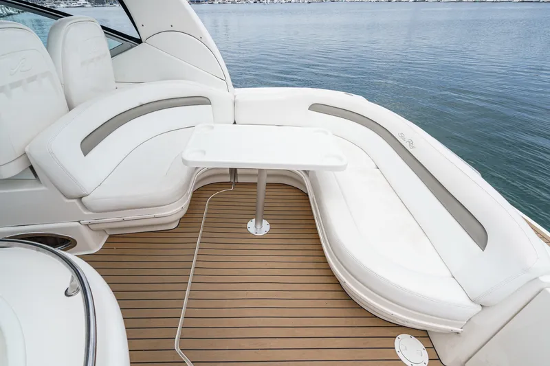 Slide: The Image of The image shows the cockpit of a 2006 Sea Ray 340 Sundancer with white seating and a table. - 11