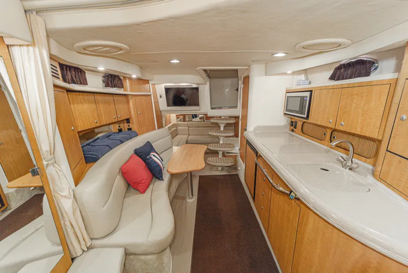 Slide: The Image of Interior of a 2006 Sea Ray 340 Sundancer with elegant kitchen and cozy seating area. - 25