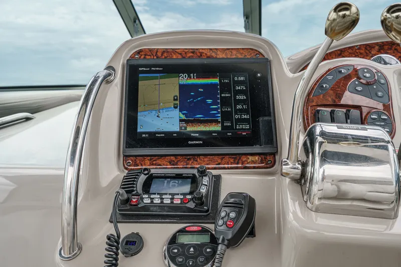 Slide: The Image of The dashboard of a 2006 Sea Ray 340 Sundancer with navigation system and radio. - 18