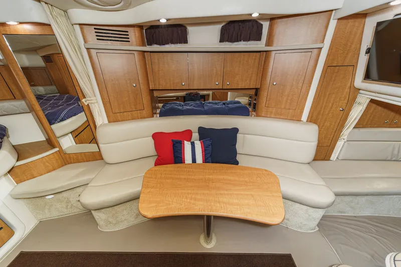 Slide: The Image of Interior of a 2006 Sea Ray 340 Sundancer featuring an elegant seating area and wooden table. - 30