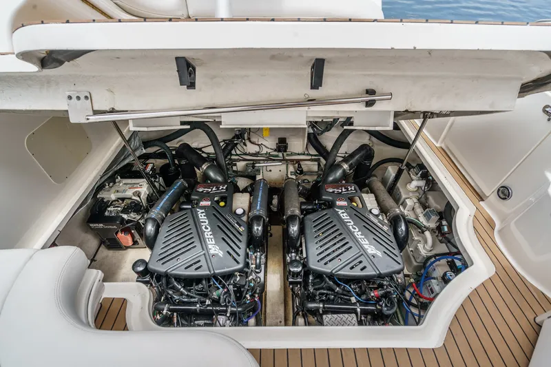 Slide: The Image of The engine compartment of a 2006 Sea Ray 340 Sundancer features two Mercury engines and technical components. - 36
