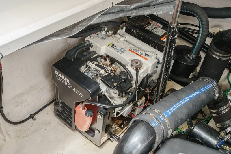 Slide: The Image of A Kohler generator in a boat engine compartment, surrounded by hoses and cables. - 40