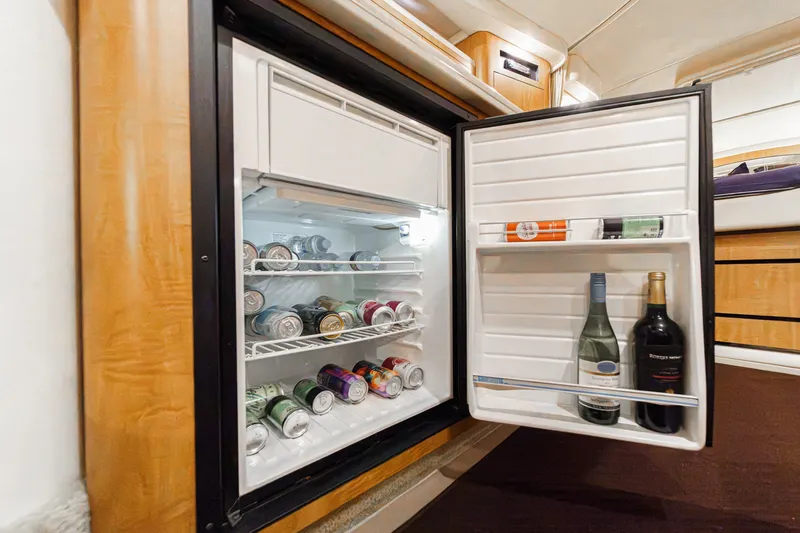 Slide: The Image of An open fridge in a 2006 Sea Ray 340 Sundancer displays beverages and wine bottles. - 29
