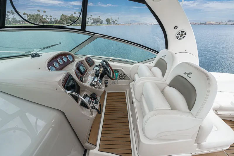 Slide: The Image of The image shows the cockpit of a 2006 Sea Ray 340 Sundancer with two white seats. - 16