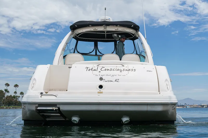 Slide: The Image of A 2006 Sea Ray 340 Sundancer on the water, with a man on board. - 8