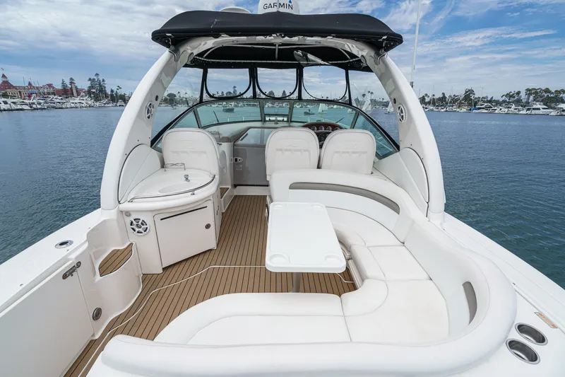 Slide: The Image of The image shows the cockpit of a 2006 Sea Ray 340 Sundancer with white leather seating and a table. - 10