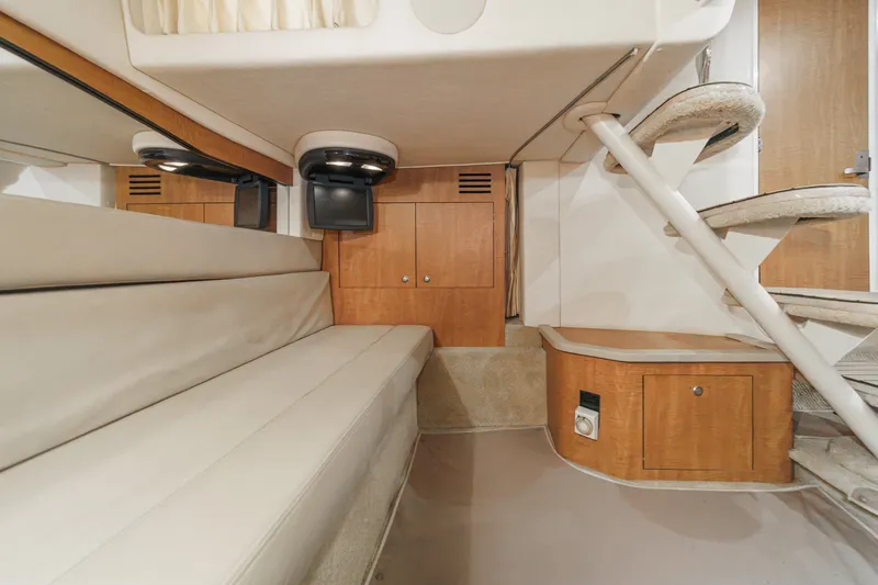 Slide: The Image of Interior of a 2006 Sea Ray 340 Sundancer with cream upholstery and wooden cabinets. - 33