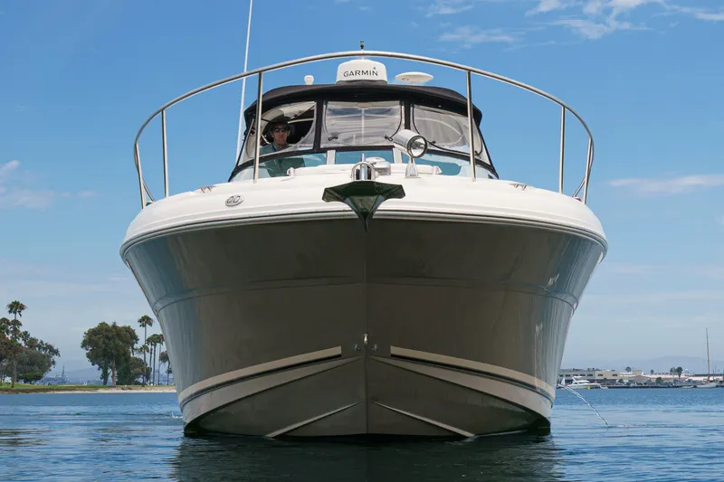 Slide: The Image of The 2006 Sea Ray 340 Sundancer cruises on calm water with a clear sky in the background. - 6