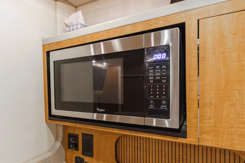 Slide: The Image of A microwave is built into a wooden paneling, surrounded by outlets and switches. - 27