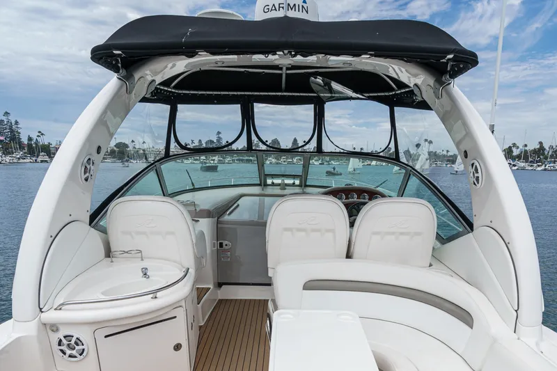 Slide: The Image of The image shows the cockpit of a 2006 Sea Ray 340 Sundancer with white seating and a sink. - 14