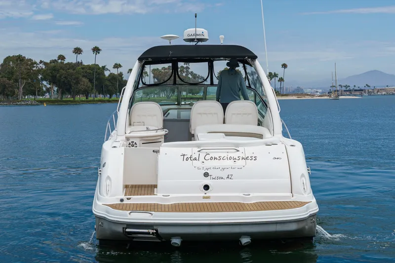 Slide: The Image of A 2006 Sea Ray 340 Sundancer on the water, featuring an open cockpit and comfortable seating. - 4