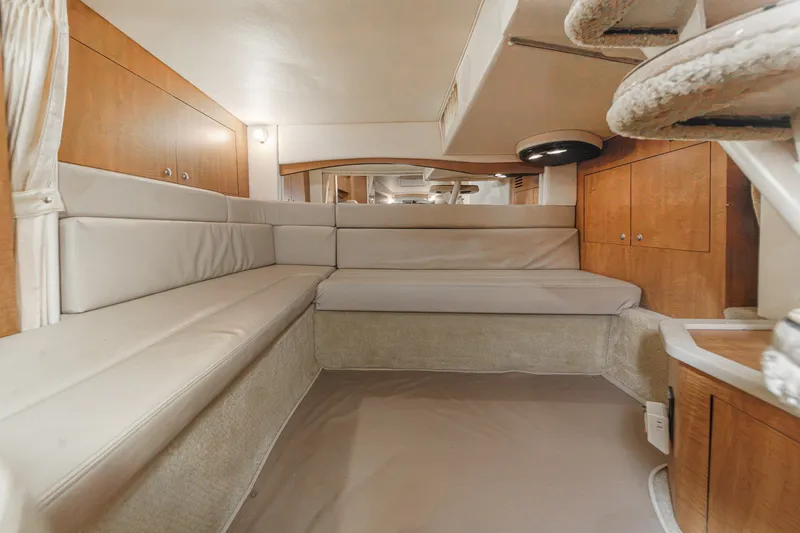 Slide: The Image of Interior of a 2006 Sea Ray 340 Sundancer with beige upholstery and wooden elements. - 32