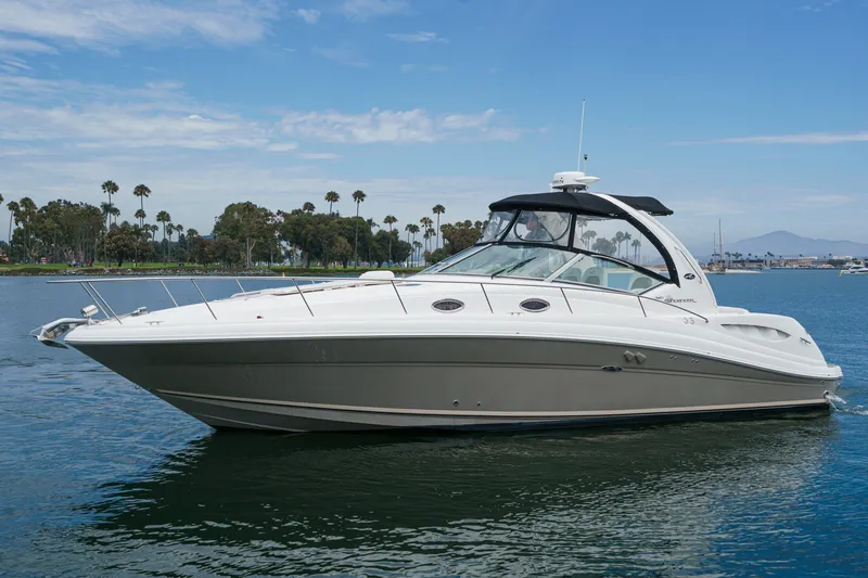 The Image of A 2006 Sea Ray 340 Sundancer on calm water with a blue sky in the background. - 0