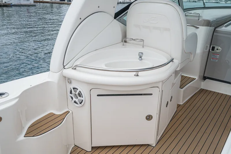 Slide: The Image of The 2006 Sea Ray 340 Sundancer features an elegant outdoor kitchenette with a sink and speaker. - 12