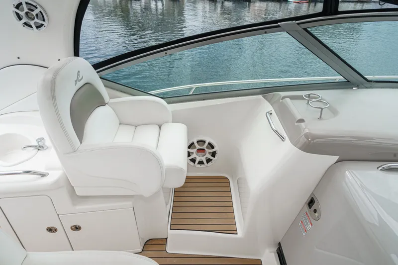 Slide: The Image of The image shows the helm of a 2006 Sea Ray 340 Sundancer with white seating and wood flooring. - 20