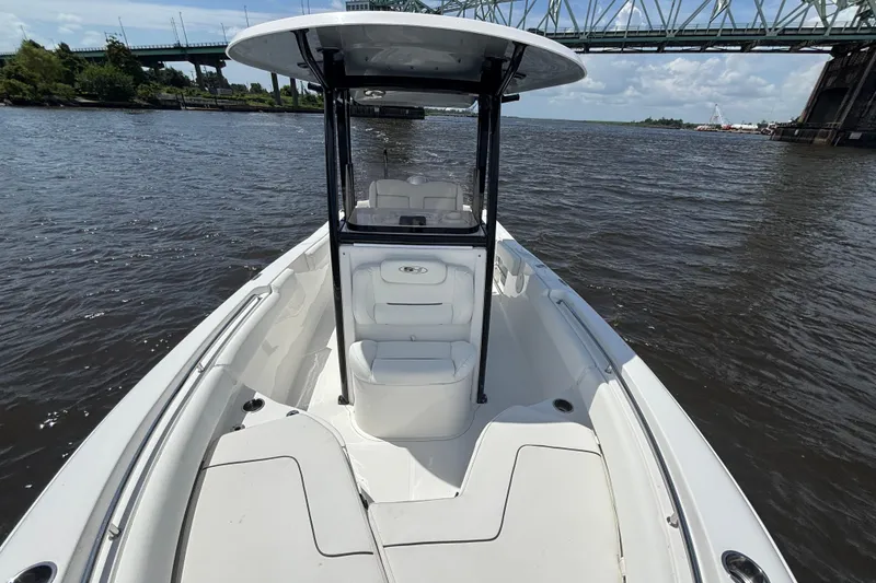 Slide: The Image of 2015 Sea Hunt Ultra 235 SE boat on water under a bridge, sunny day. - 14