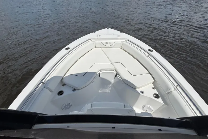 Slide: The Image of 2015 Sea Hunt Ultra 235 SE boat bow view on calm water. - 5