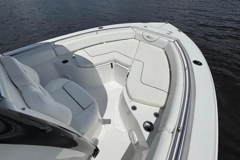 Slide: The Image of 2015 Sea Hunt Ultra 235 SE boat interior with white seating on water. - 6