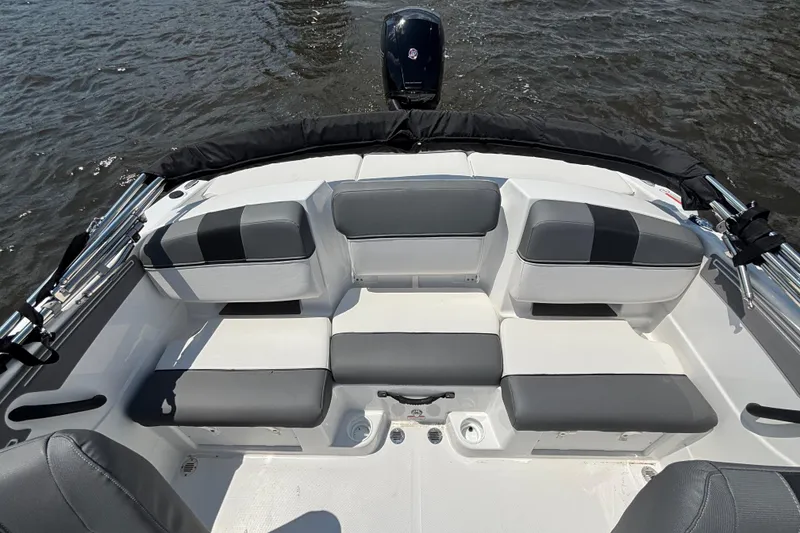 Slide: The Image of 2024 Tahoe T21 boat interior with gray and white seating on the water. - 9